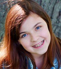 stock photo teen girl wearing braces with colored elastics